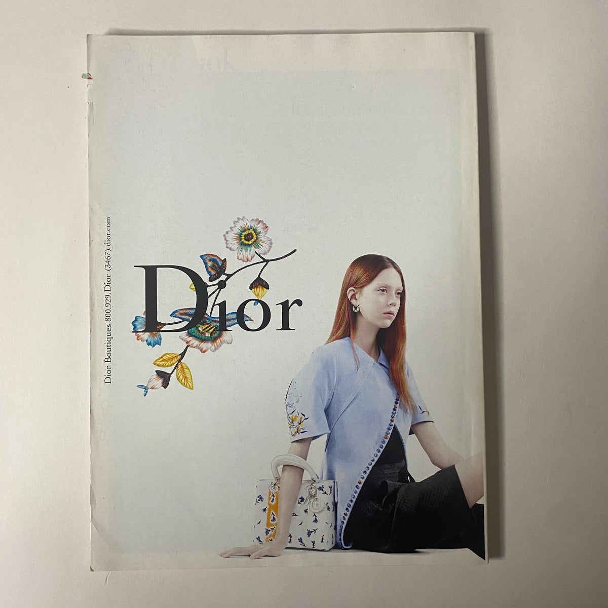 Vogue Magazine February 2015 Dakota Johnson Cover featuring a Dior advertisement with a young model, highlighting fashion and beauty styles of the season.