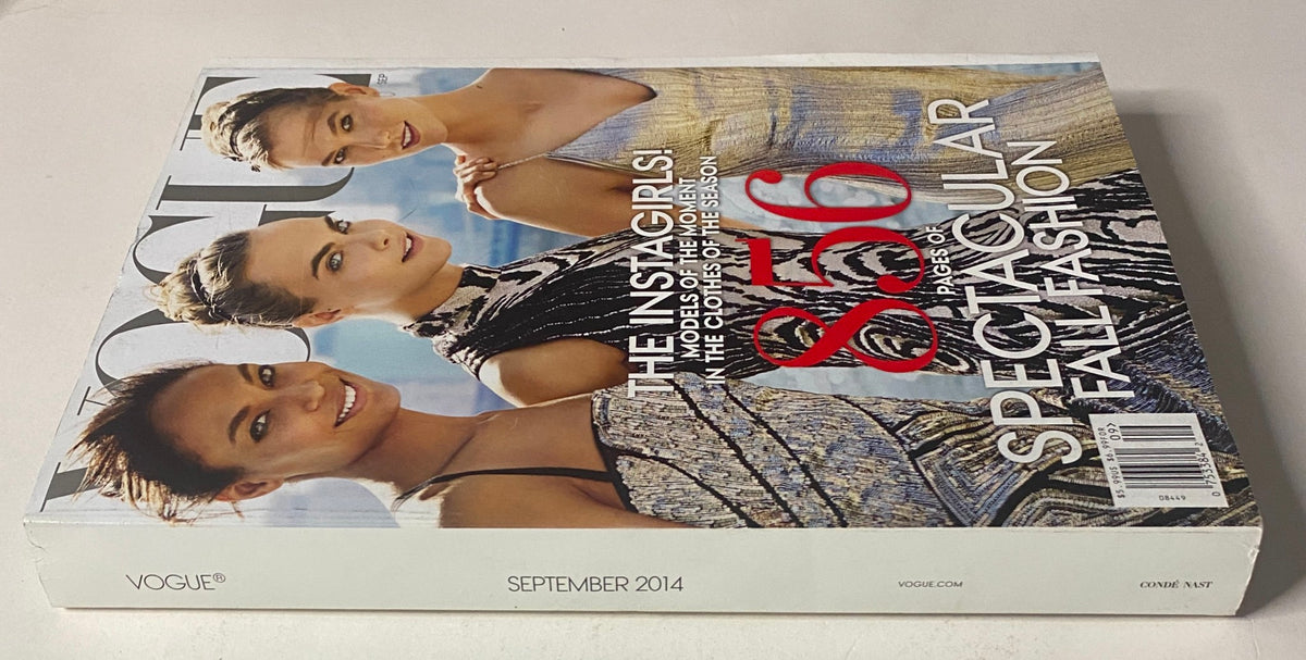 Spine view of Vogue Magazine September 2014 showcasing Cara Delevingne and Karlie Kloss, with 856 pages of stunning fashion content.