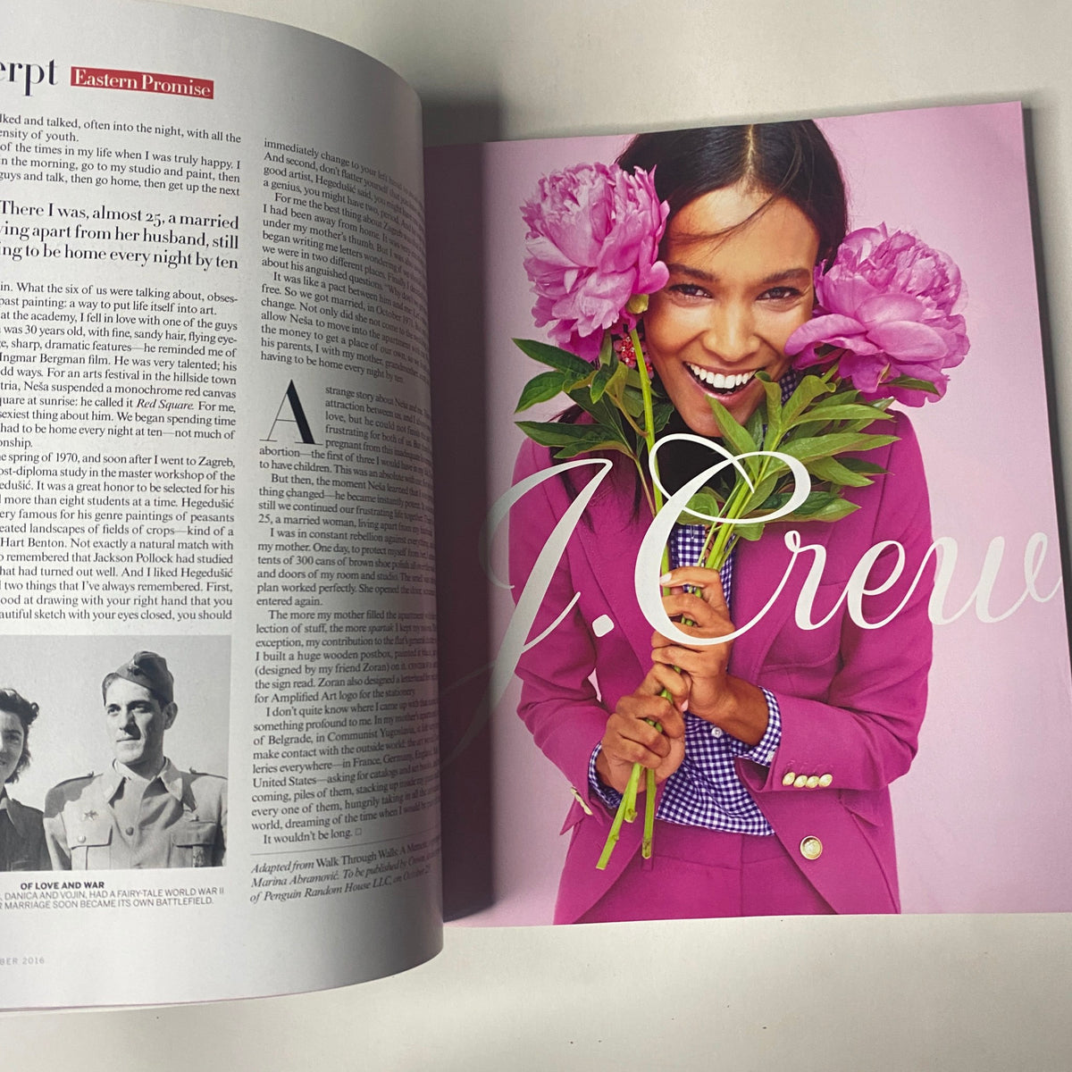 Vogue Magazine September 2016 double-page spread showcasing a joyful model holding peonies, styled in vibrant J. Crew attire.