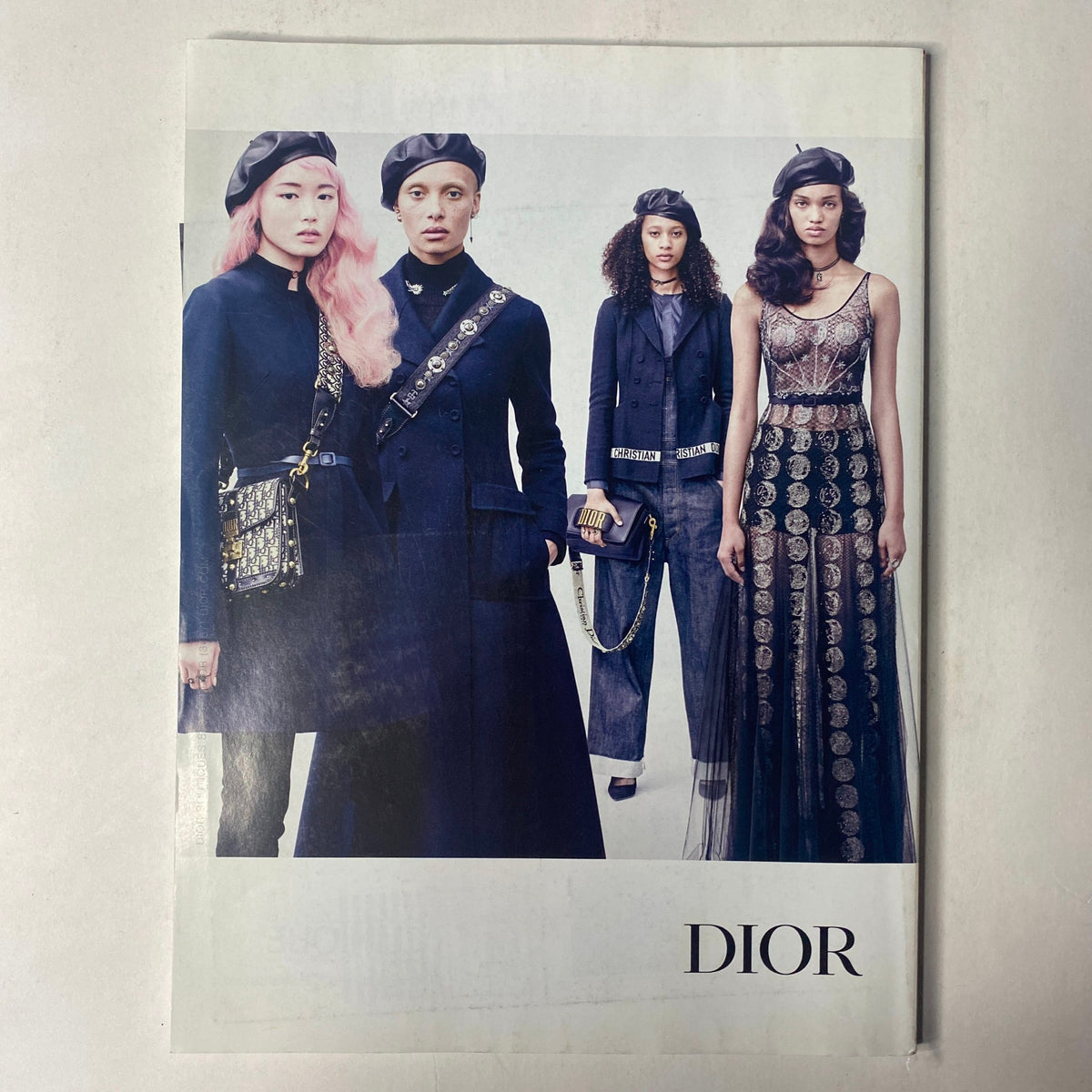 Dior fashion spread showcasing four diverse models in elegant attire and dramatic poses, highlighting contemporary fashion trends, featured in Vogue Magazine August 2017 with Gigi Hadid and Zayn Malik on the cover.