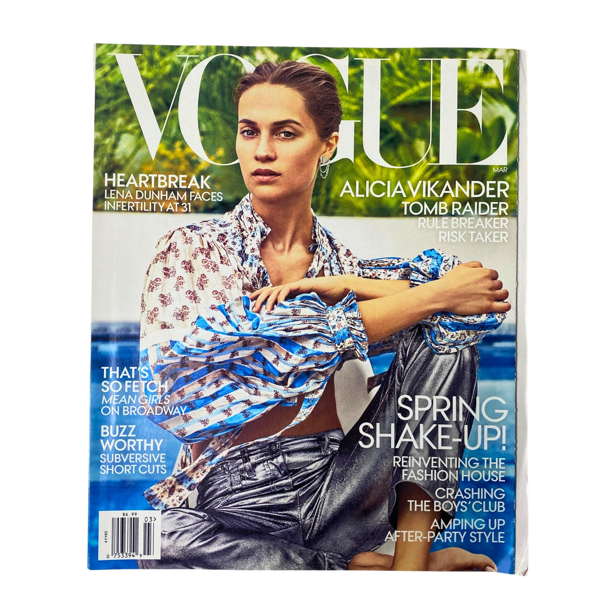 Vogue Magazine March 2018 featuring Alicia Vikander on the cover. The cover showcases her in a stylish outfit, highlighting her role in Tomb Raider, along with fashion-focused text elements.
