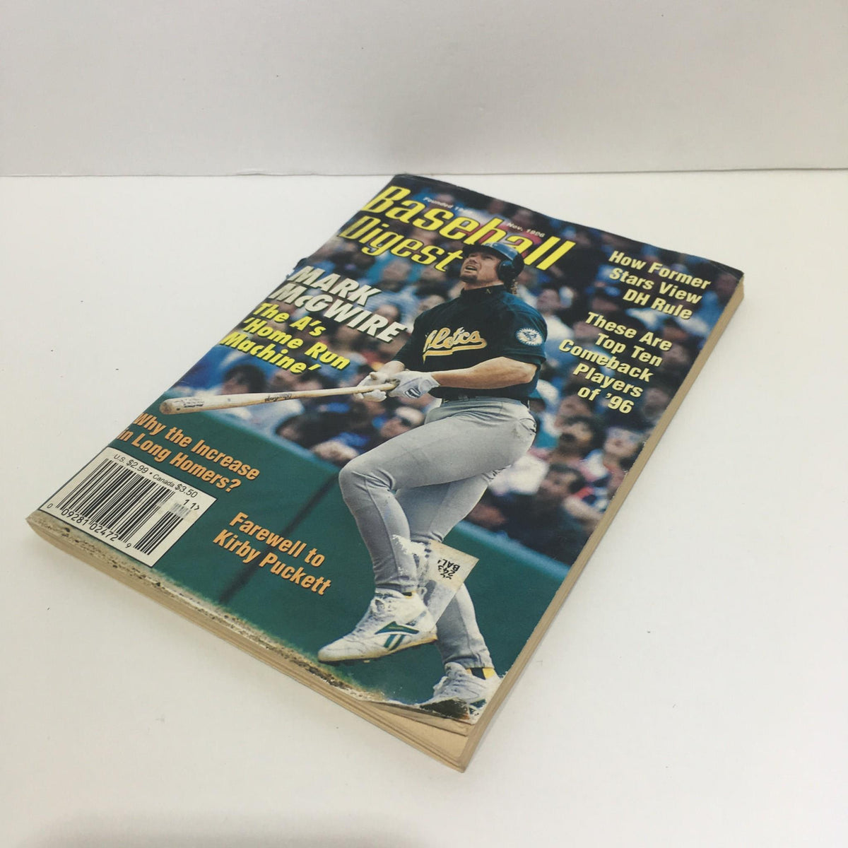Side angle of the November 1996 Baseball Digest Magazine with Mark McGwire on the cover, emphasizing the magazine's thickness and condition.