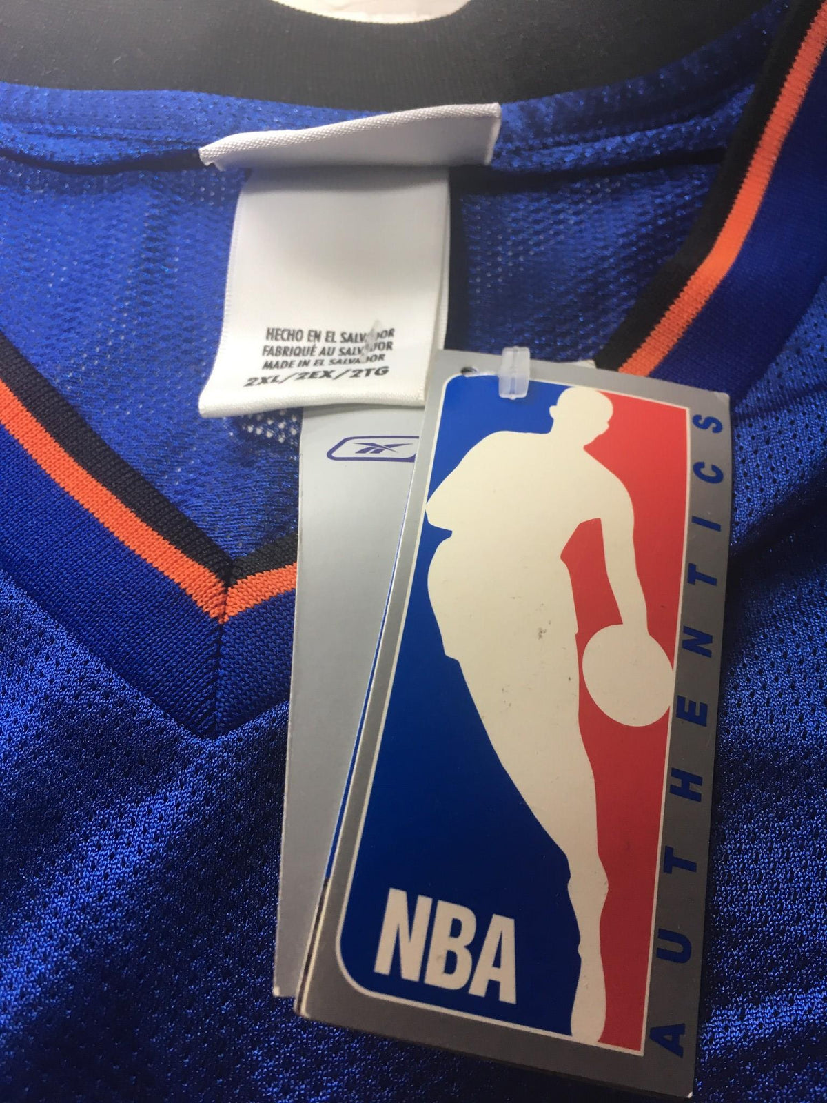 Detailed view of the collar and tag of the NBA New York Knicks Stephon Marbury #3 jersey size 2XL, showcasing the NBA logo and authenticity tag.