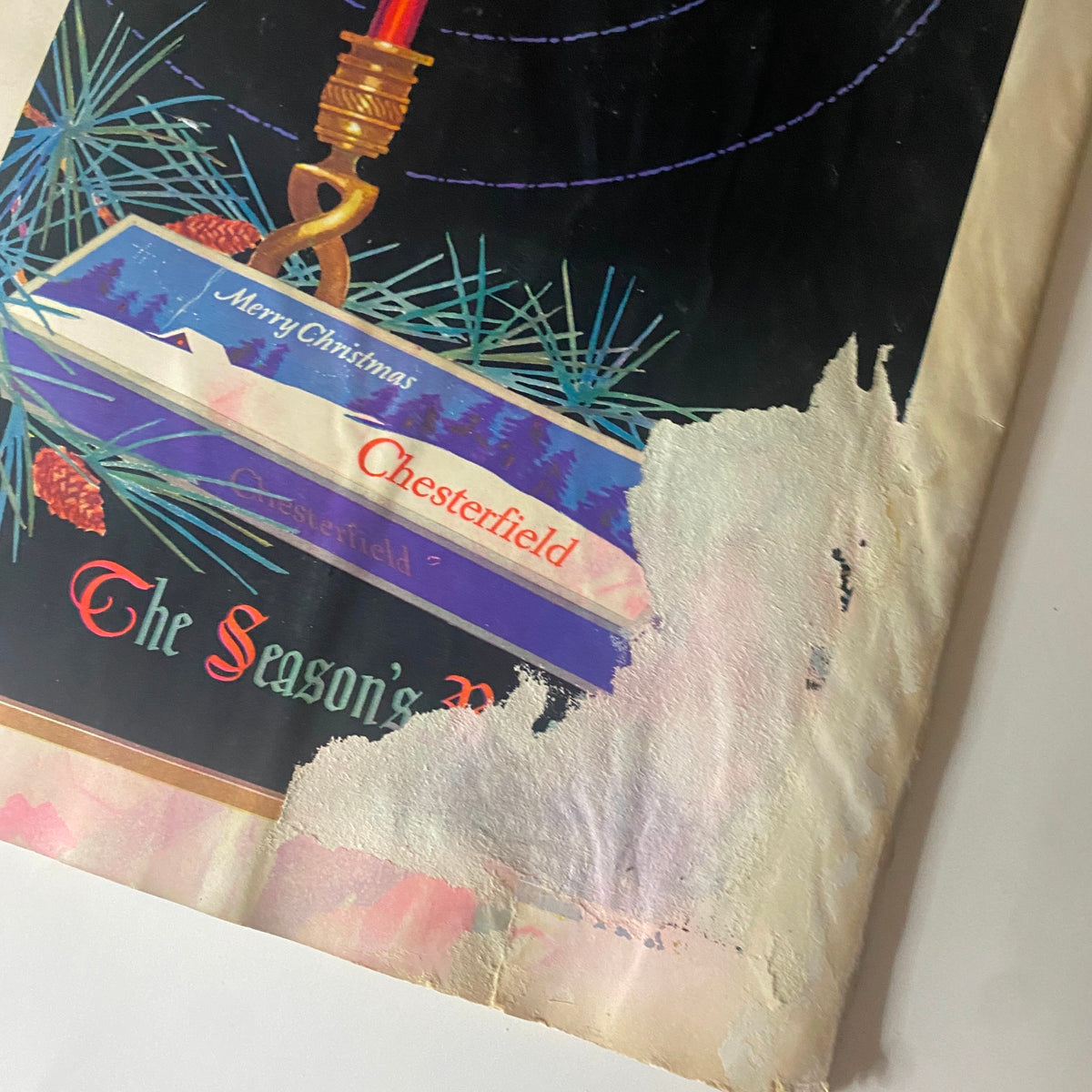 Close-up of the Chesterfield Cigarettes advertisement from The New Yorker Complete Magazine December 24, 1927, showing damaged artwork and holiday decorations.