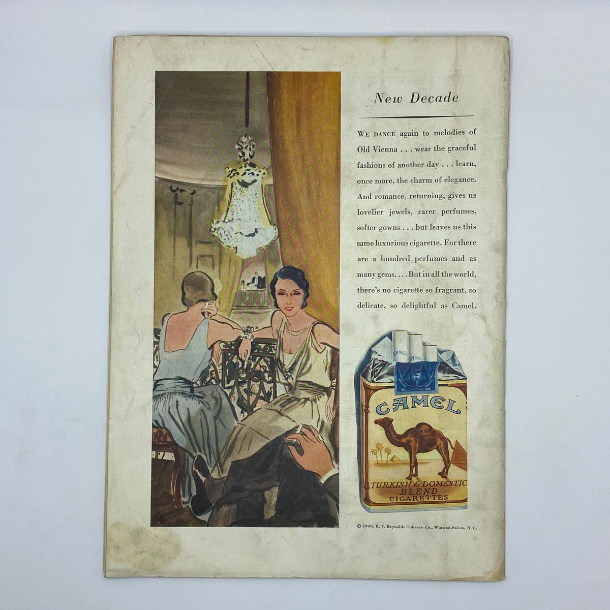 Vintage advertisement from The New Yorker Complete Magazine December 27, 1930, featuring the 'New Decade' theme with elegant women in evening gowns, a stylish lamp, and a Camel cigarette ad. Captivating design reflecting the fashion and culture of the early 1930s.