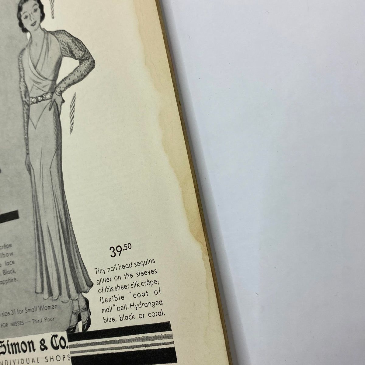 Close-up of an advertisement for sheer silk crêpe dresses from The New Yorker Complete Magazine November 14, 1931, highlighting intricate embellishments.
