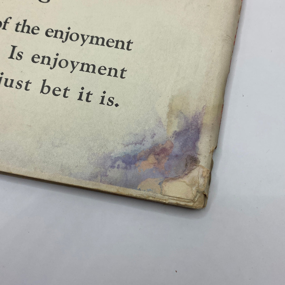 Close-up of the bottom corner of The New Yorker Complete Magazine March 24, 1928 showing damage and discoloration, highlighting the vintage condition of the magazine.