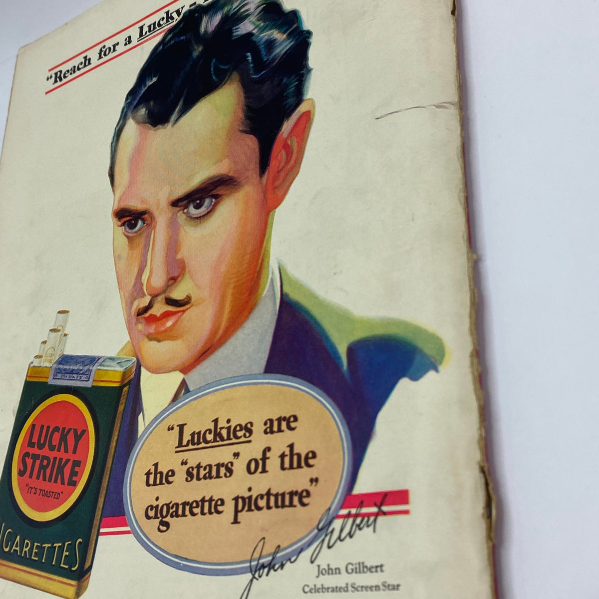 Close-up of the Lucky Strike cigarette advertisement in The New Yorker Complete Magazine April 27, 1929, showcasing John Gilbert and the tagline 'Luckies are the stars of the cigarette picture.'