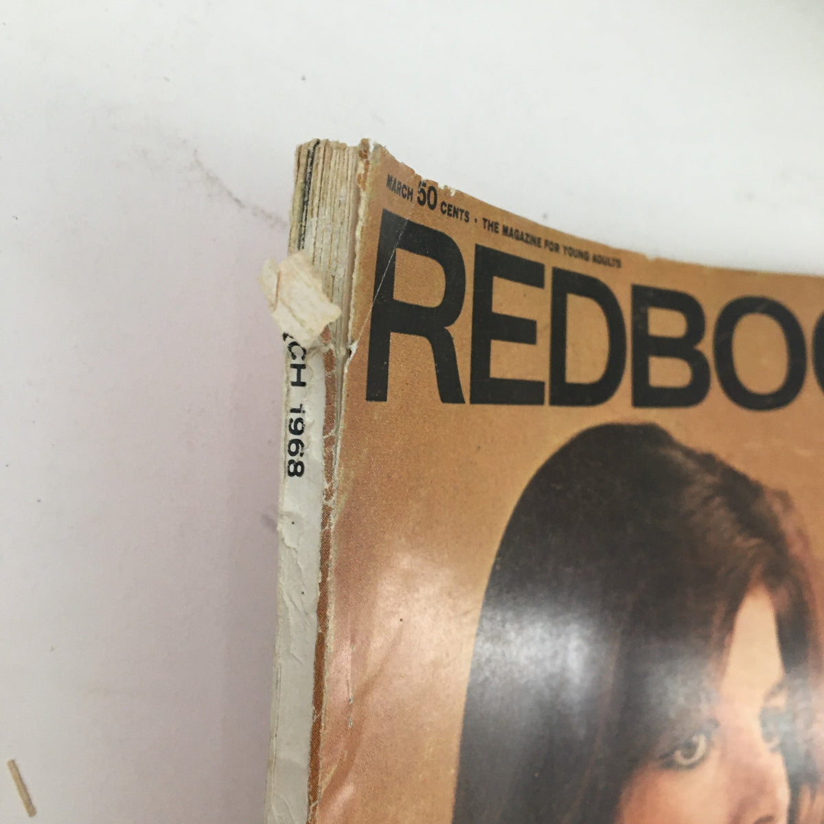Close-up of the spine of the March 1968 Redbook Magazine, highlighting its vintage wear and the publication date.