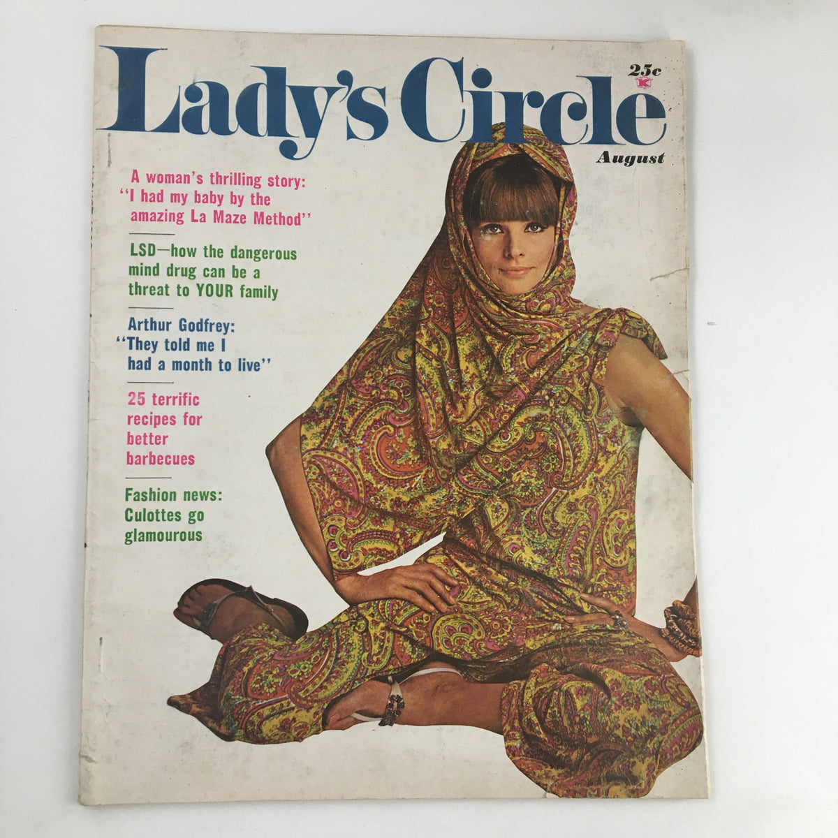Lady's Circle Magazine August 1966 cover featuring a woman in a colorful paisley outfit, showcasing articles on parenting, LSD, Arthur Godfrey, and fashion trends of the 1960s.