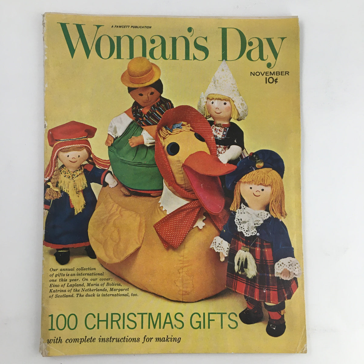 Cover of Woman's Day Magazine November 1962 featuring Eino of Lapland and Maria of Bolivia with festive doll characters and a large duck prop.