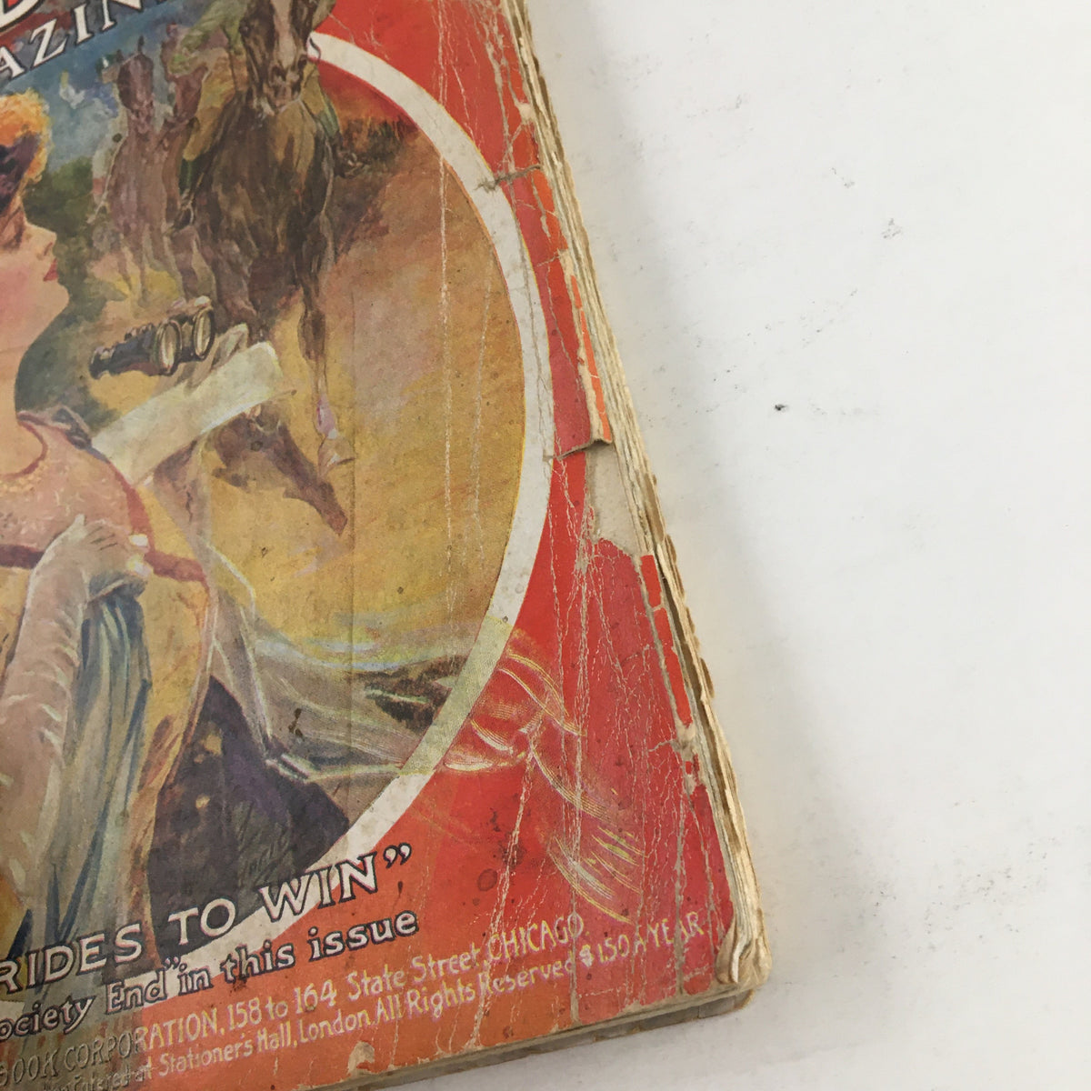 Cover of The Redbook Magazine May 1910 featuring the story 'Love Rides To Win' with vintage artwork, visible wear, and unique historical charm.
