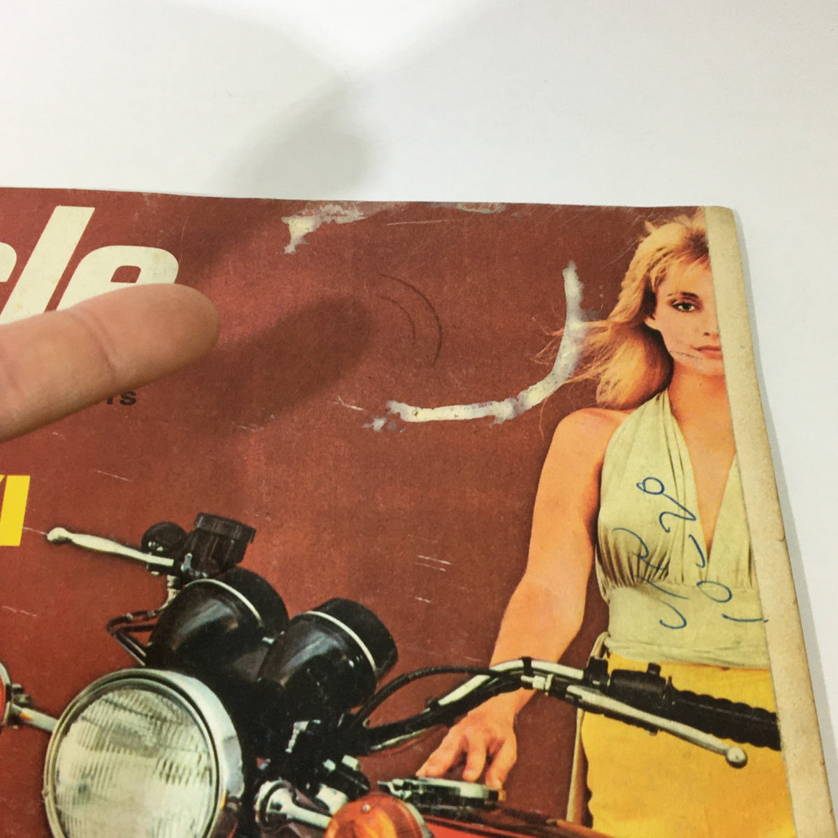 Detail of the top section of VTG Cycle Magazine November 1972 cover, highlighting the title 'Every Inch A King' with a model in the background.