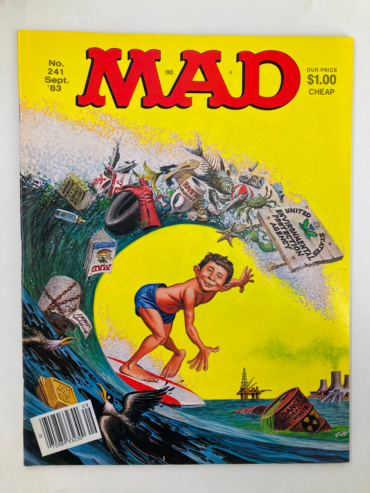 Cover of Mad Magazine September 1983 No. 241 titled 'Surfing Trash', featuring a boy surfing amidst various ocean debris, capturing the humor and cultural critique characteristic of the magazine.