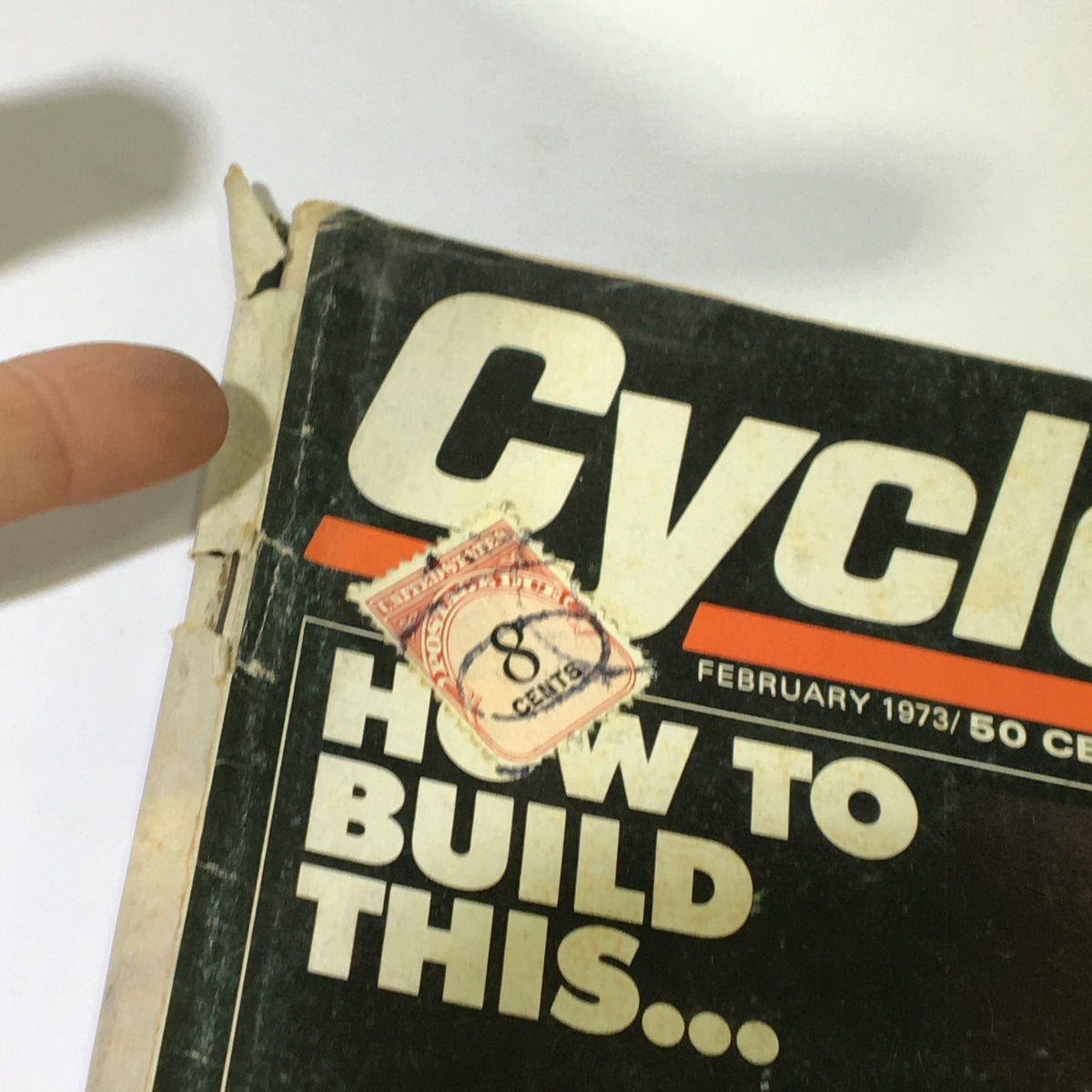 Top corner of the cover of VTG Cycle Magazine February 1973 displaying an 8-cent price tag and the magazine's title in vintage font.