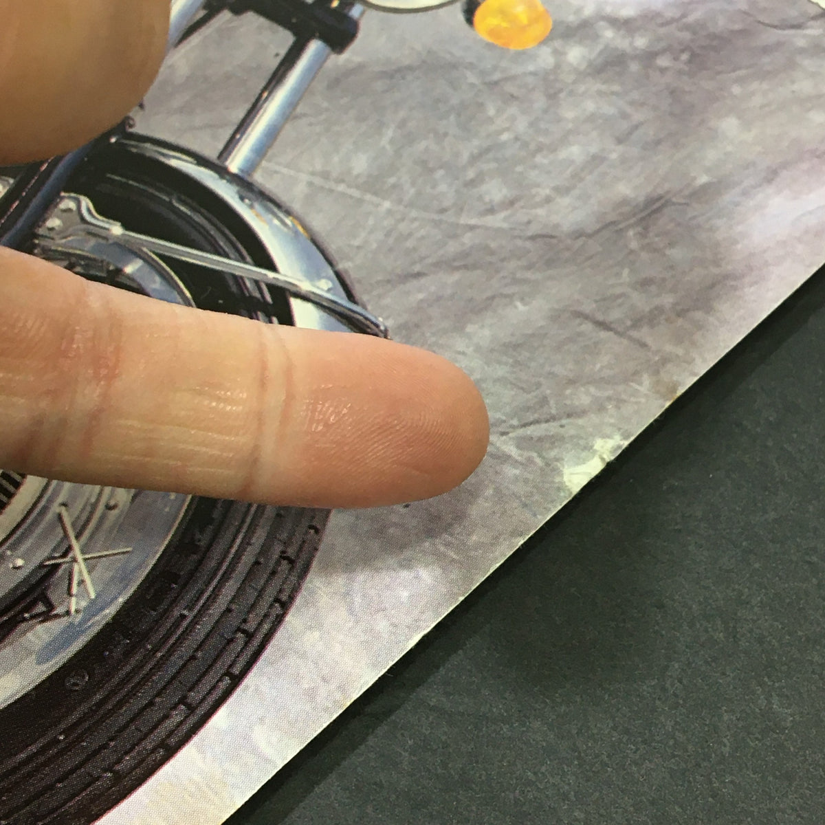 Close-up view of the cover of Bike Journal Magazine January 2007, highlighting the Suzuki Vintage Racer and a finger pointing at the lower corner of the magazine.