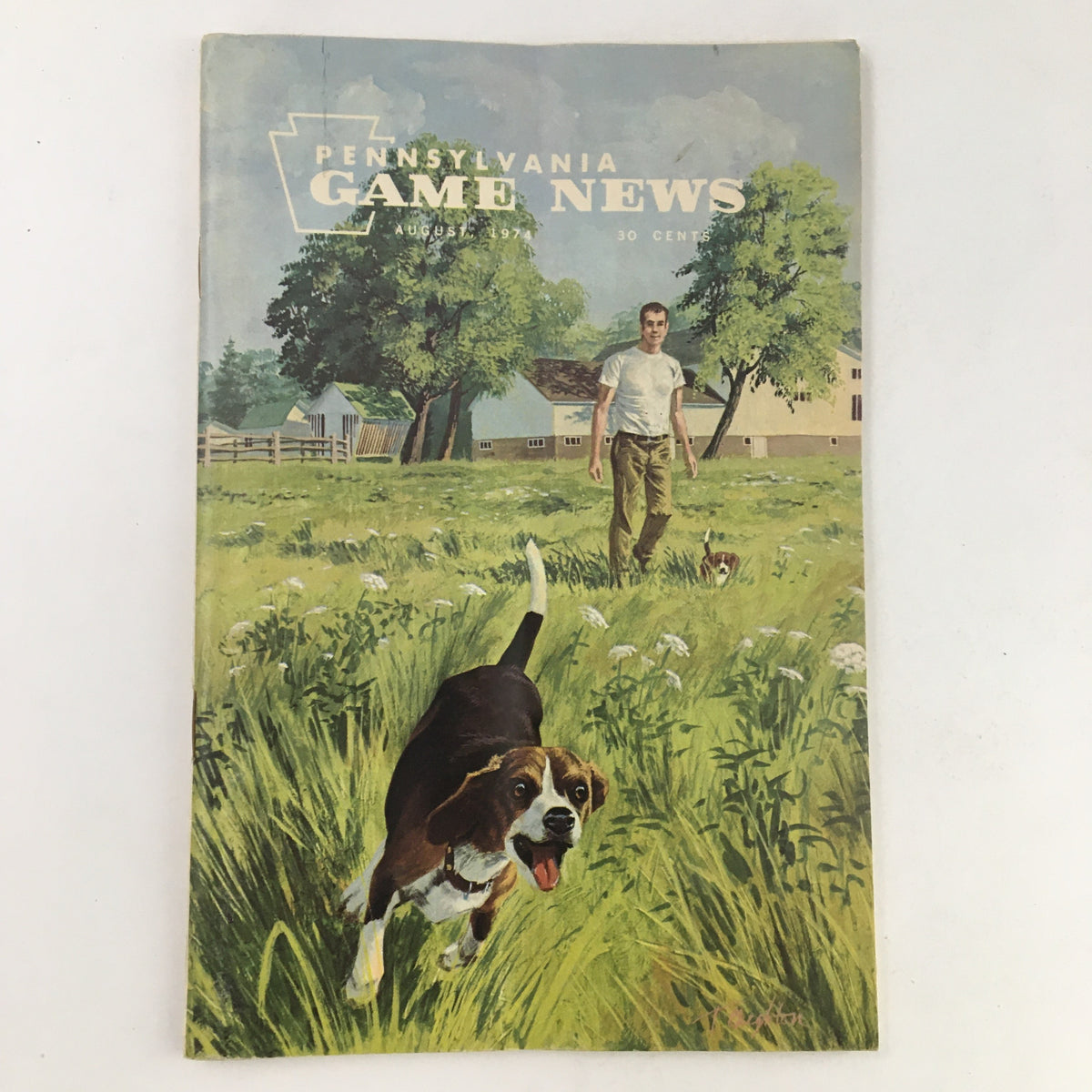 Cover of Pennsylvania Game News August 1974 Wildlife Lands Problem Solved, featuring a man in a field with a playful dog, illustrating wildlife and nature themes.