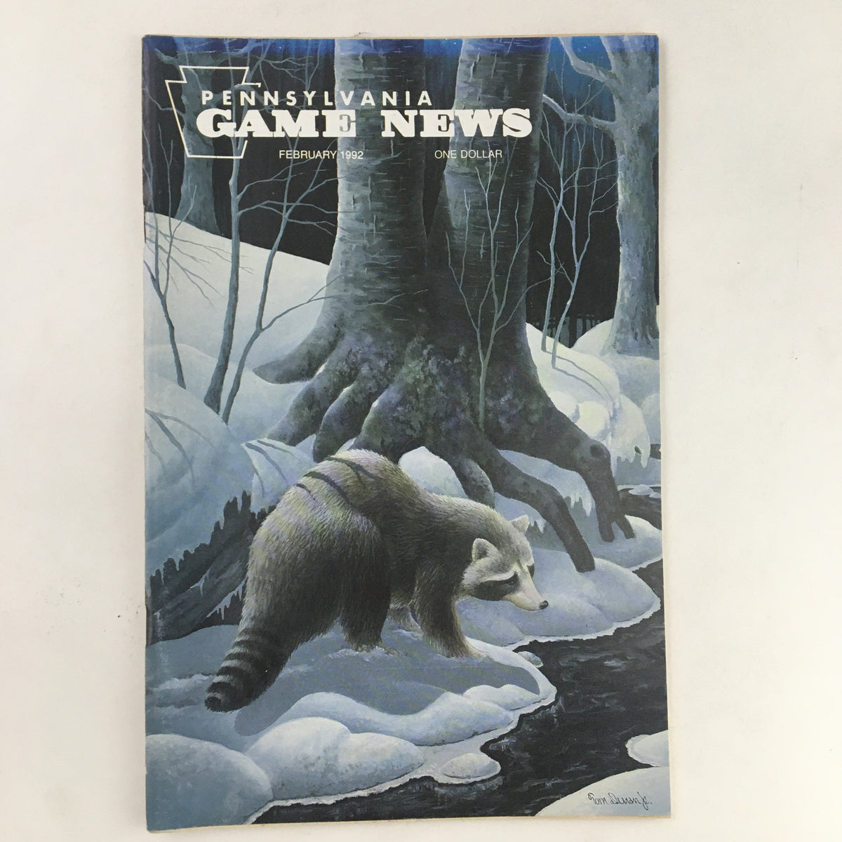 Cover image of Pennsylvania Game News February 1992 issue featuring a winter scene with a raccoon near a stream, highlighting wildlife themes and outdoor adventure.