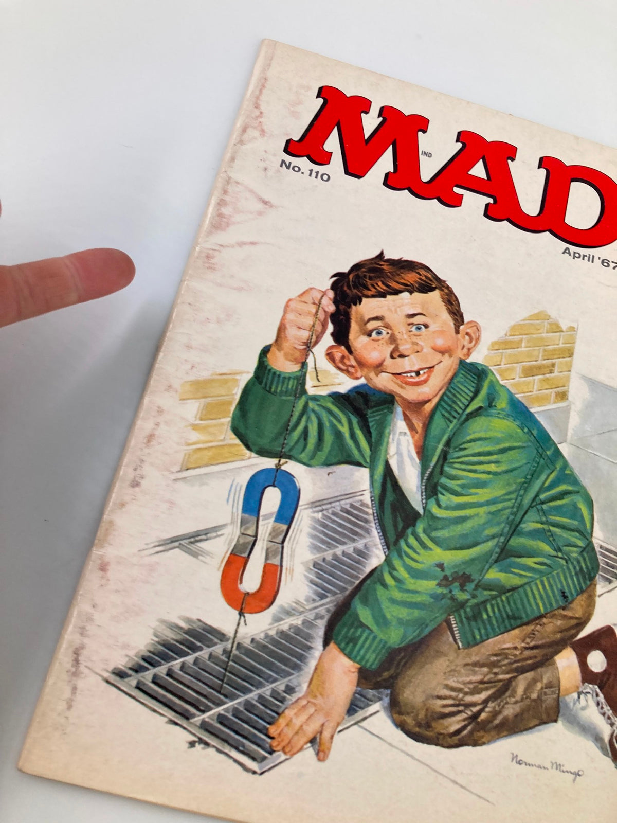 Close-up view of the cover of Mad Magazine April 1967 No. 110, highlighting the boy with a magnet and the magazine title.