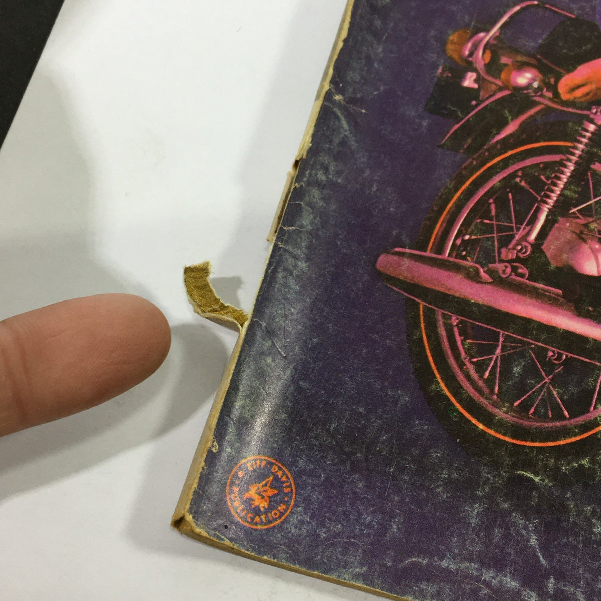 Close-up of the edge of the July 1970 Cycle magazine highlighting some wear and tear, emphasizing its vintage condition.
