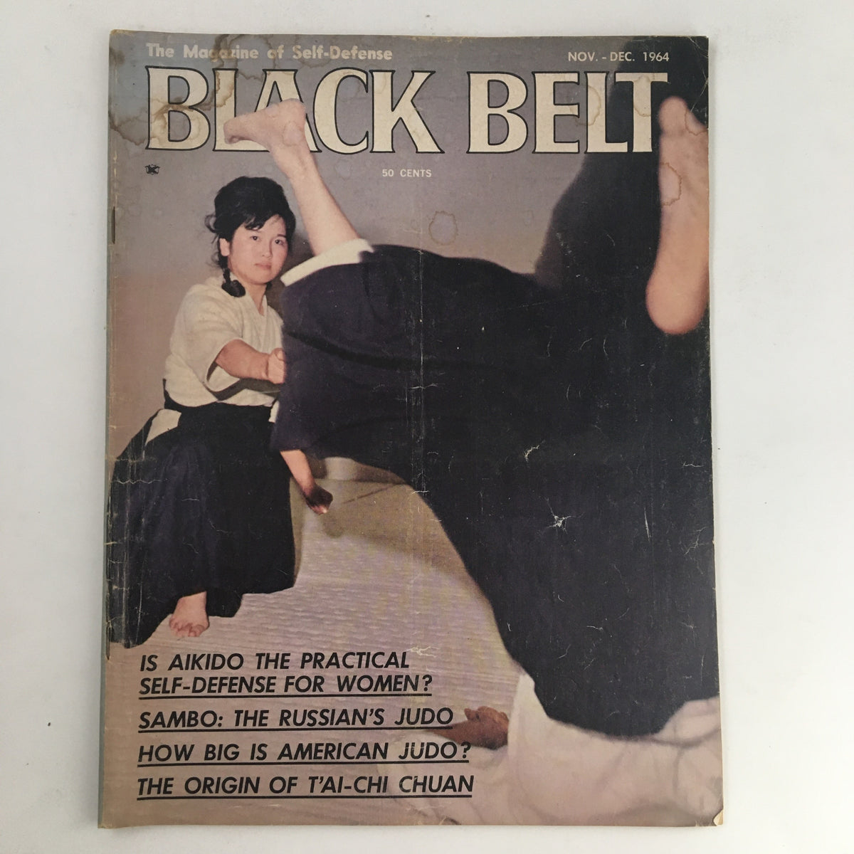 Cover of Black Belt Magazine December 1964 featuring Mariye K. Yano demonstrating a throw in judo, showcasing martial arts techniques and elements from the 1960s era.