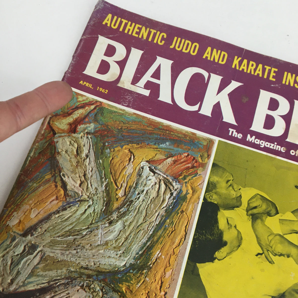 Close-up of the cover of Black Belt Magazine April 1962 Vol. 1 No. 3 highlighting the title and artwork, representing the era's martial arts influence.