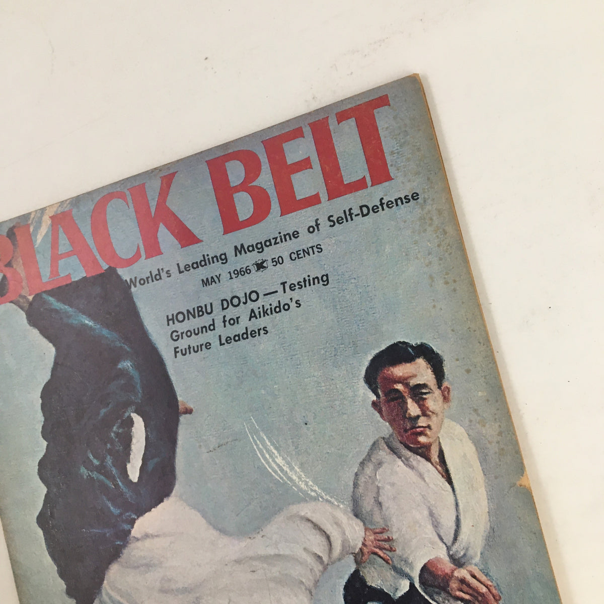 Close-up of the cover of Black Belt Magazine May 1966, Vol. 4 No. 5, showcasing martial arts imagery and the issue title.