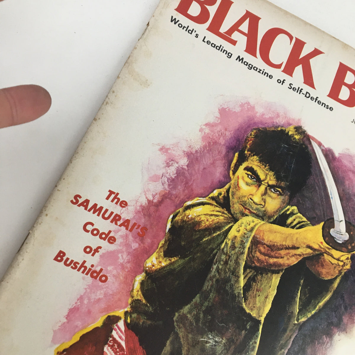 Close-up of the cover of Black Belt Magazine July 1966 Vol. 4 No. 6, illustrating a Samurai warrior ready with a sword, emphasizing The Samurai Code of Bushido.
