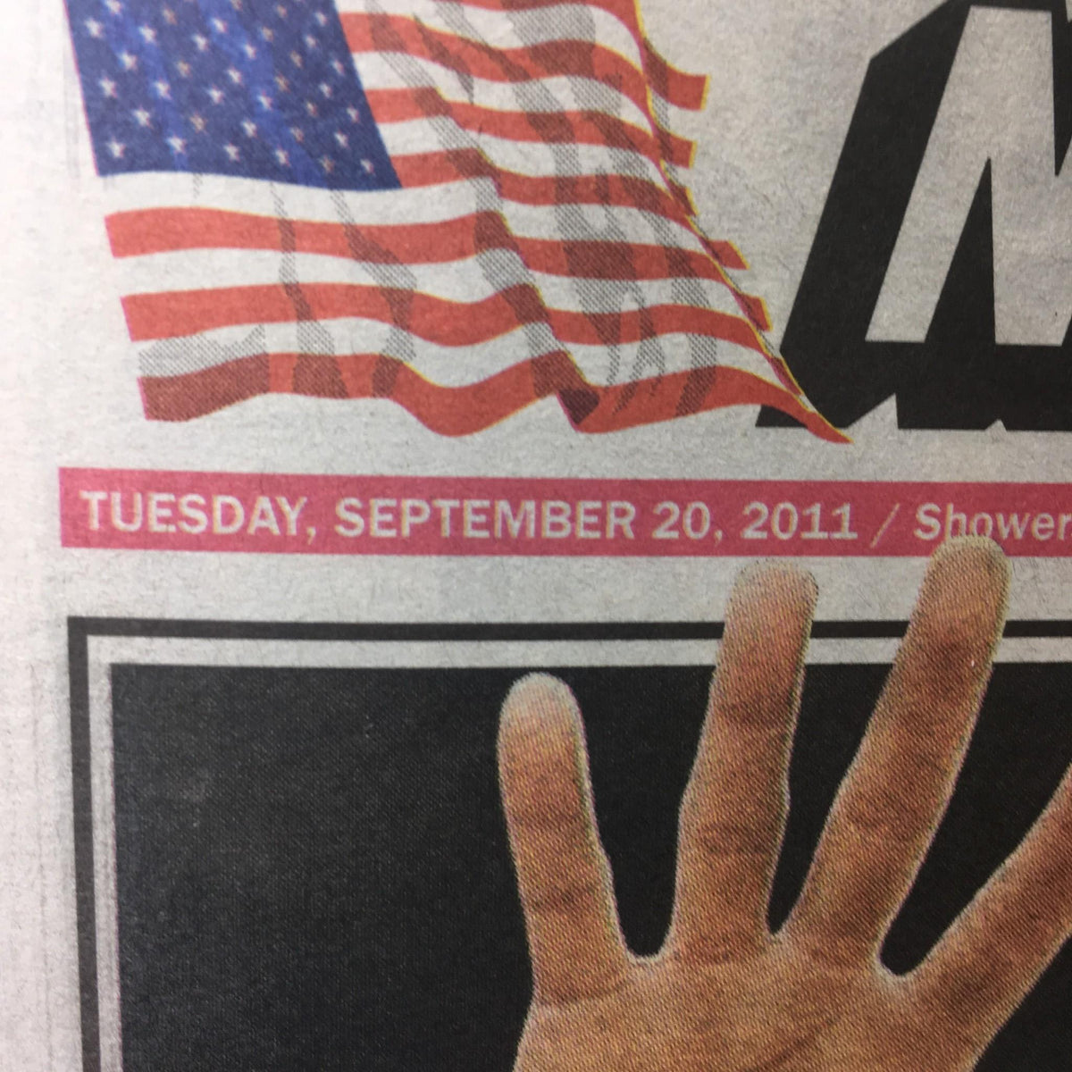 Close-up of the New York Post highlighting the date 'Tuesday, September 20, 2011' alongside an image of a hand gesture, part of the story 'IN A TIX FIX 17 scandal cops facing indict today'.