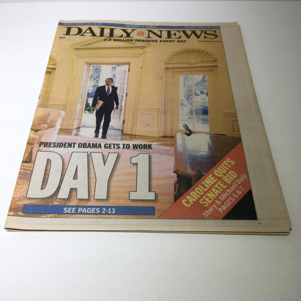 NY Daily News: Jan 22 2009 President Obama Gets To Work - Cover of the newspaper displaying President Obama on his first day at work in the Oval Office, with a headline emphasizing 'DAY 1'.
