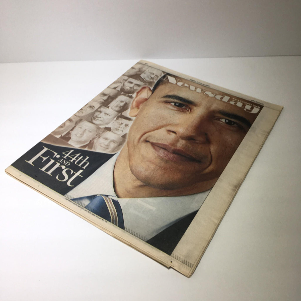 Side view of the Newsday publication from January 20, 2009, featuring Barack Obama on the cover with the inscription '44th and First' alongside images of historical leaders.