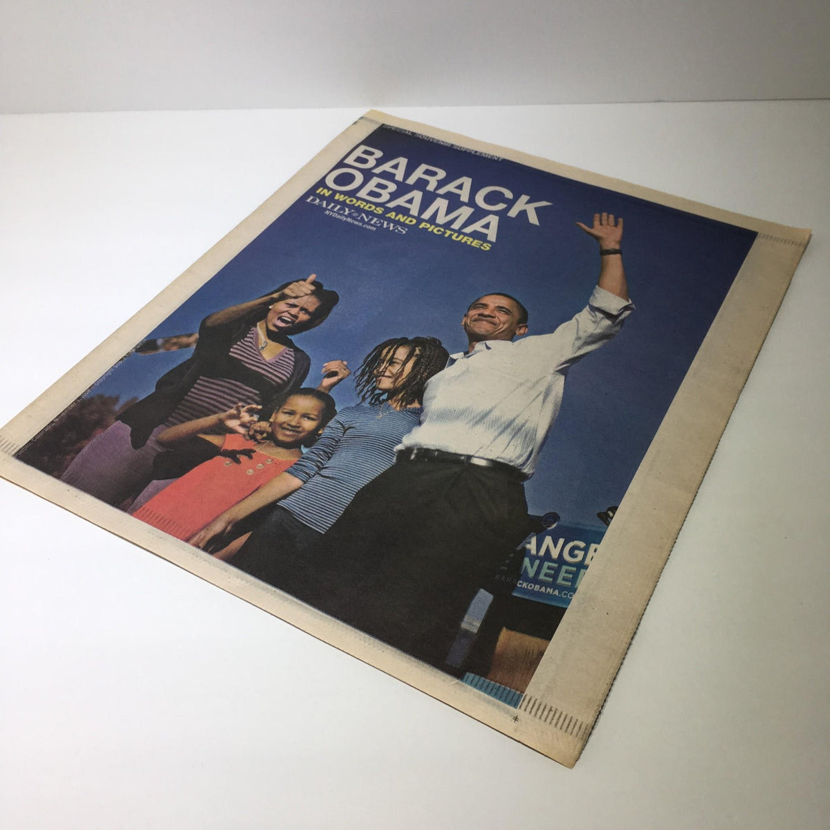 Cover of NY Daily News featuring Barack Obama with children, highlighting a pivotal moment from his campaign.