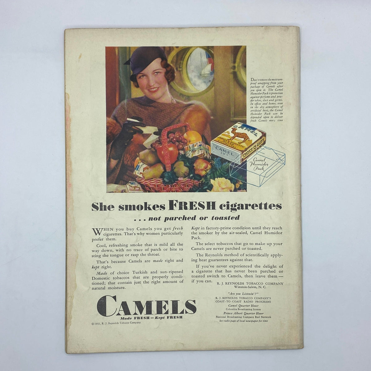 Vintage advertisement for Camels cigarettes, featuring a woman with fruit and a pack of cigarettes, from The New Yorker May 14, 1932.