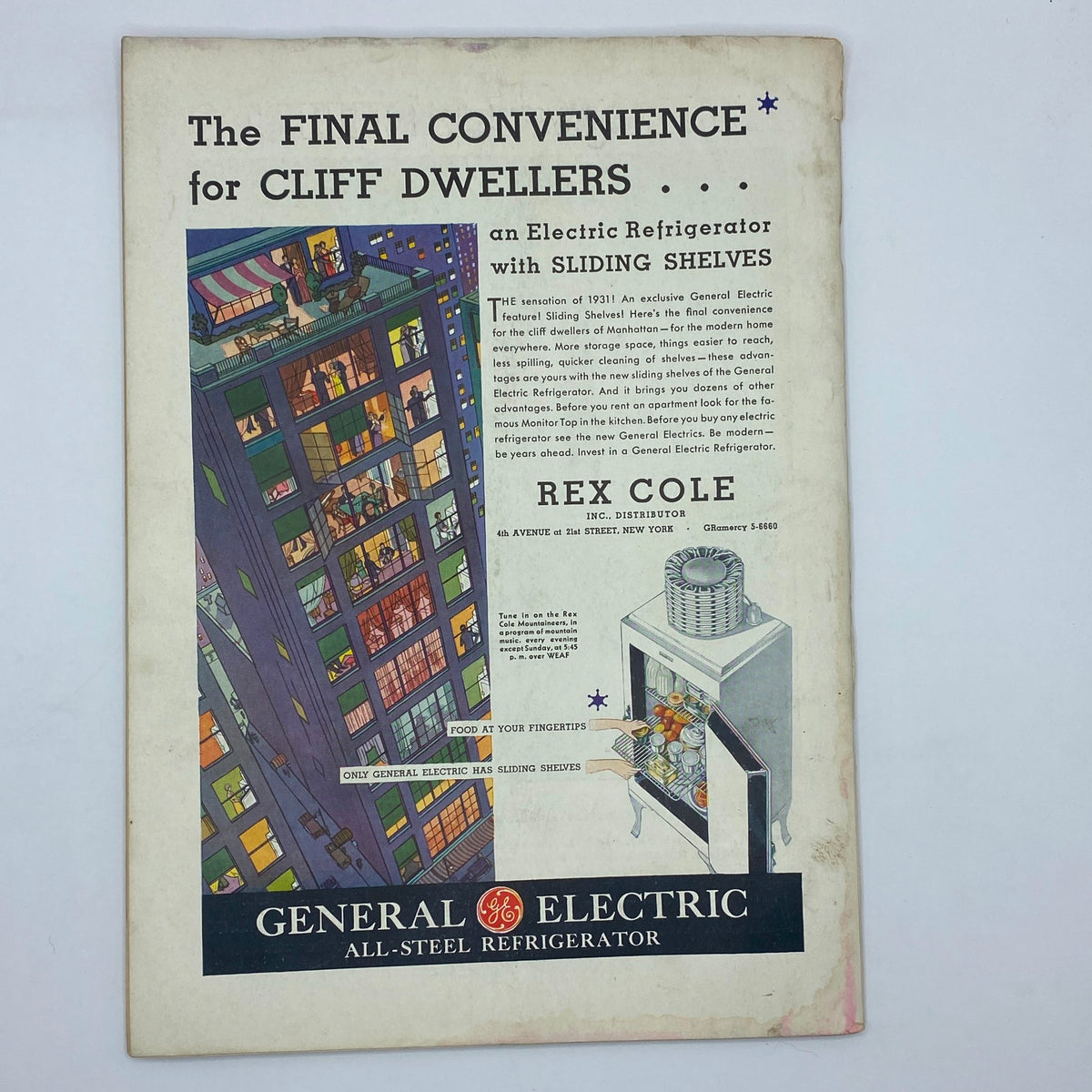 Ad for General Electric All-Steel Refrigerator featuring sliding shelves, highlighting the convenience for Manhattan cliff dwellers, from the October 17, 1931 edition of The New Yorker magazine with Adolph Kronengold cover.