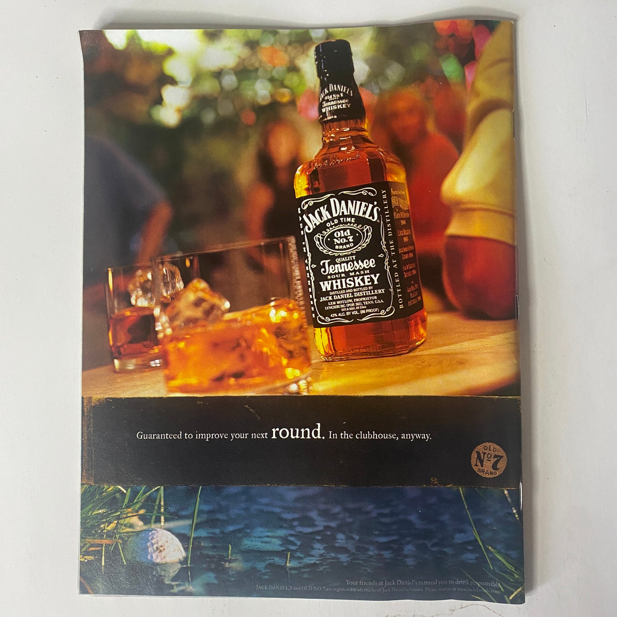 Advertisement for Jack Daniel's Tennessee Whiskey in Sports Illustrated Magazine September 23, 2002, showcasing a whiskey bottle and glasses, emphasizing the enjoyment for social gatherings.