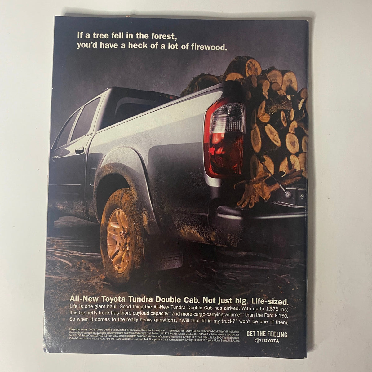 Advertisement for the All-New Toyota Tundra Double Cab showcasing its rugged design and powerful features, emphasizing its capability for heavy-duty tasks. From Sports Illustrated Magazine April 26, 2004, 50th Anniversary Special: The Pictures.