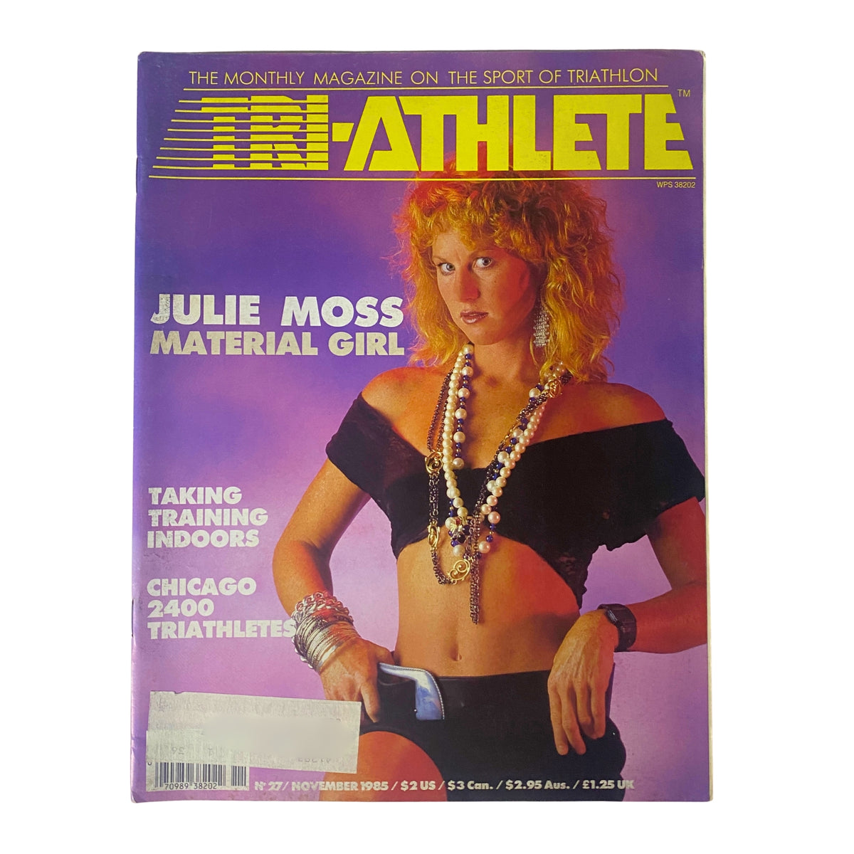 Tri-Athlete Magazine cover from November 1985, featuring Julie Moss as 'Material Girl'. The cover highlights the magazine's focus on triathlons with vibrant colors and a notable interview about triathlon culture.
