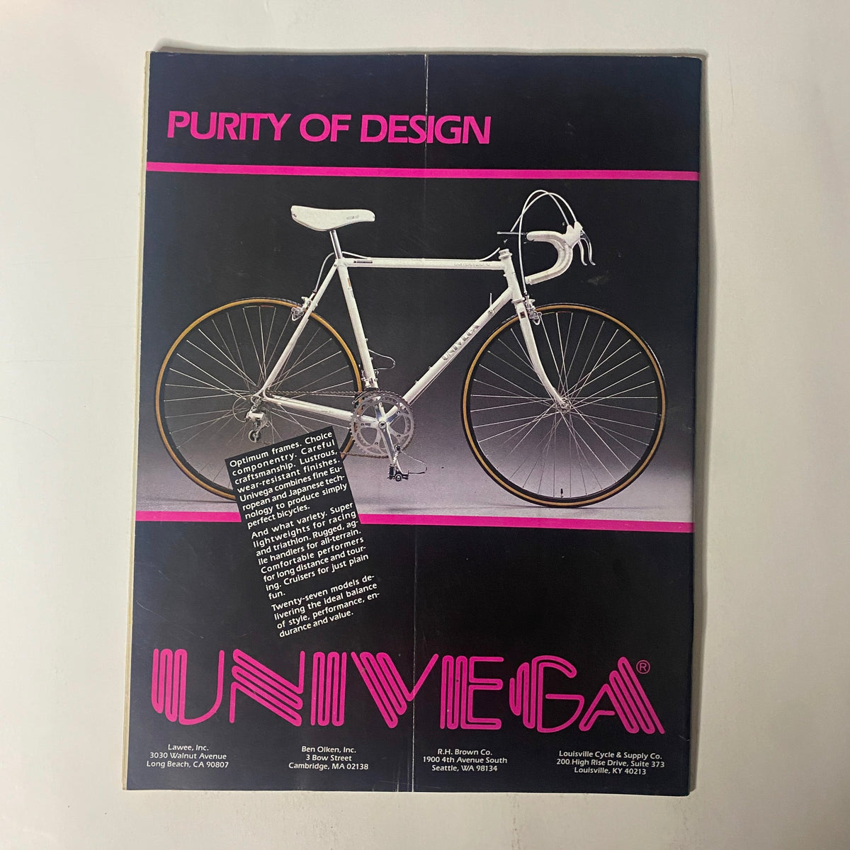 Advertisement for Univega bicycles featured in Triathlete Magazine, October 1986, No. 38, showcasing a white bicycle with the slogan 'Purity of Design'.