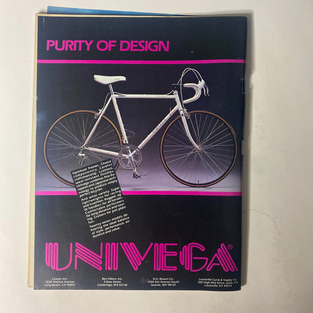 Cover of Triathlete Magazine April 1986 featuring a white bike with the title 'Purity of Design' and showcasing the Univega brand. This issue highlights water swimmer and triathlete Eney Jones of Florida.
