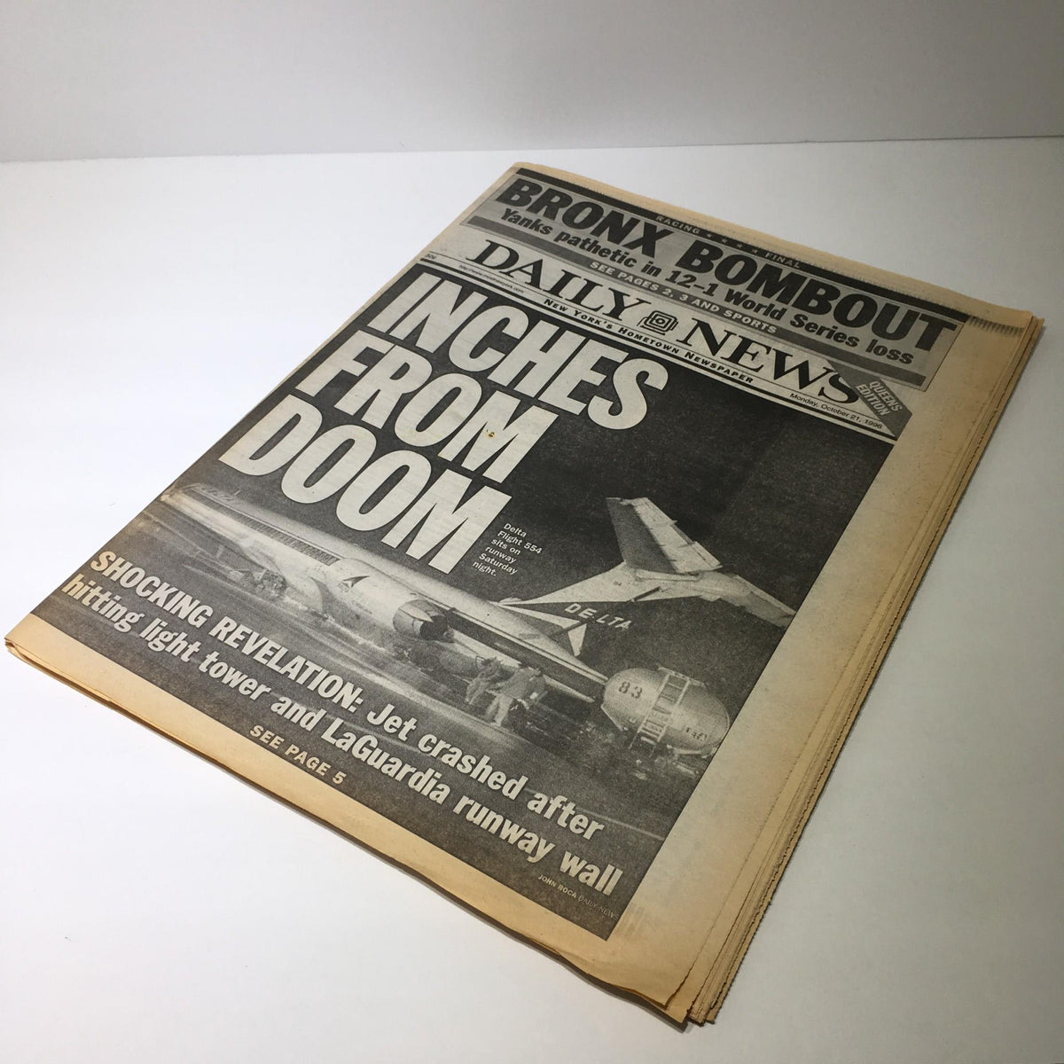 The front page of the NY Daily News, titled 'Inches From Doom', depicting a dramatic incident with a jet in the background.