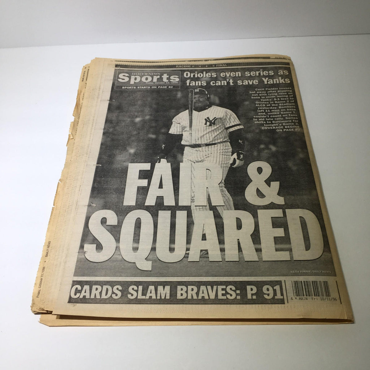Reverse side of the NY Daily News from October 11, 1996, showing the sports section with the headline 'FAIR & SQUARED' amidst the news of a suicide try in a Bronco chase.