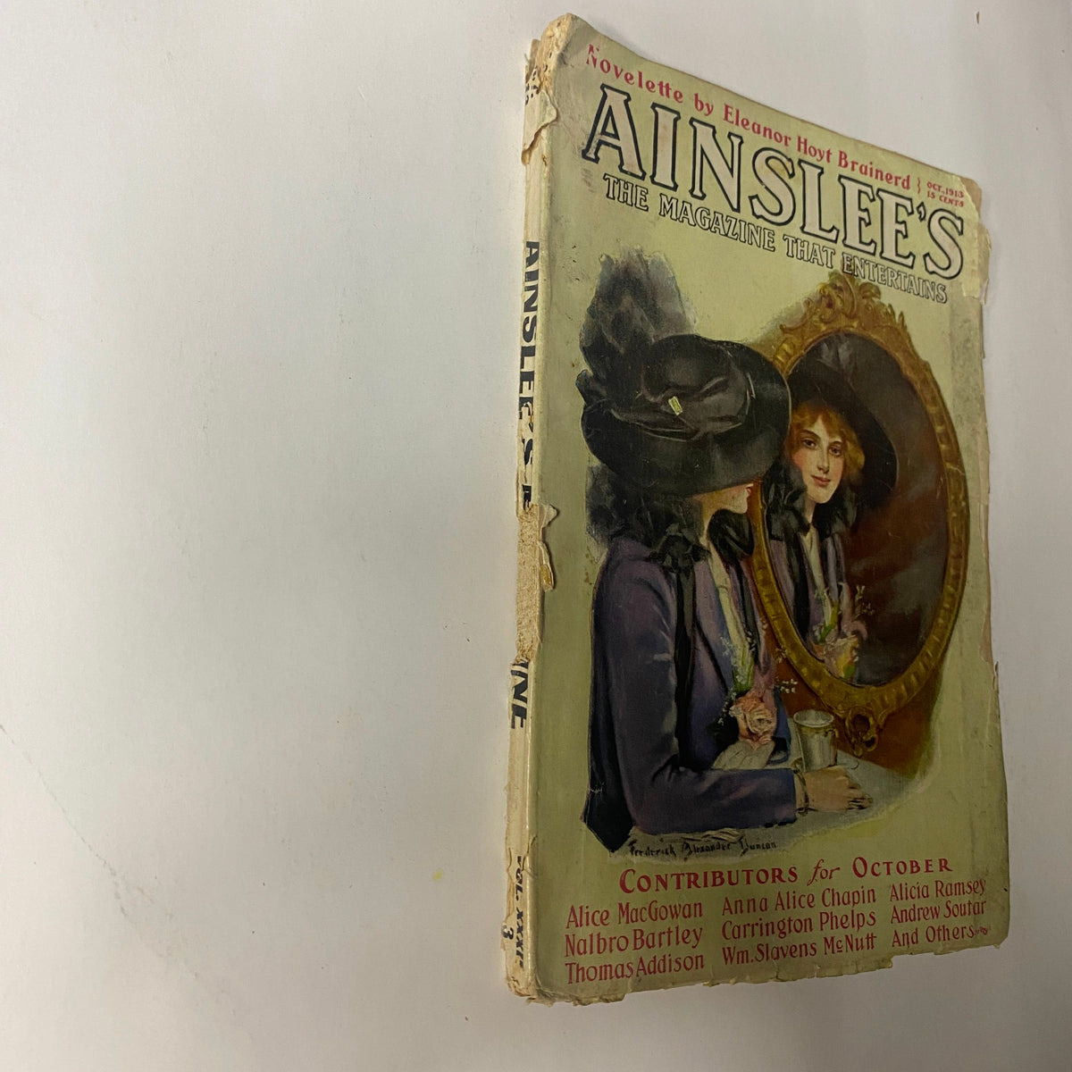 Side view of the October 1913 Ainslee's Magazine showcasing the cover art of a woman and the publication details.