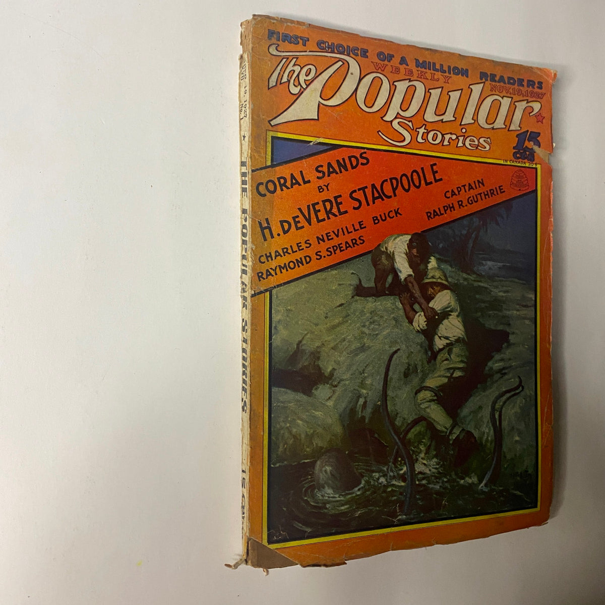 Side view of The Popular Stories magazine, November 19, 1927, highlighting the Coral Sands title by H. de Vere Stacpoole and eye-catching cover art.
