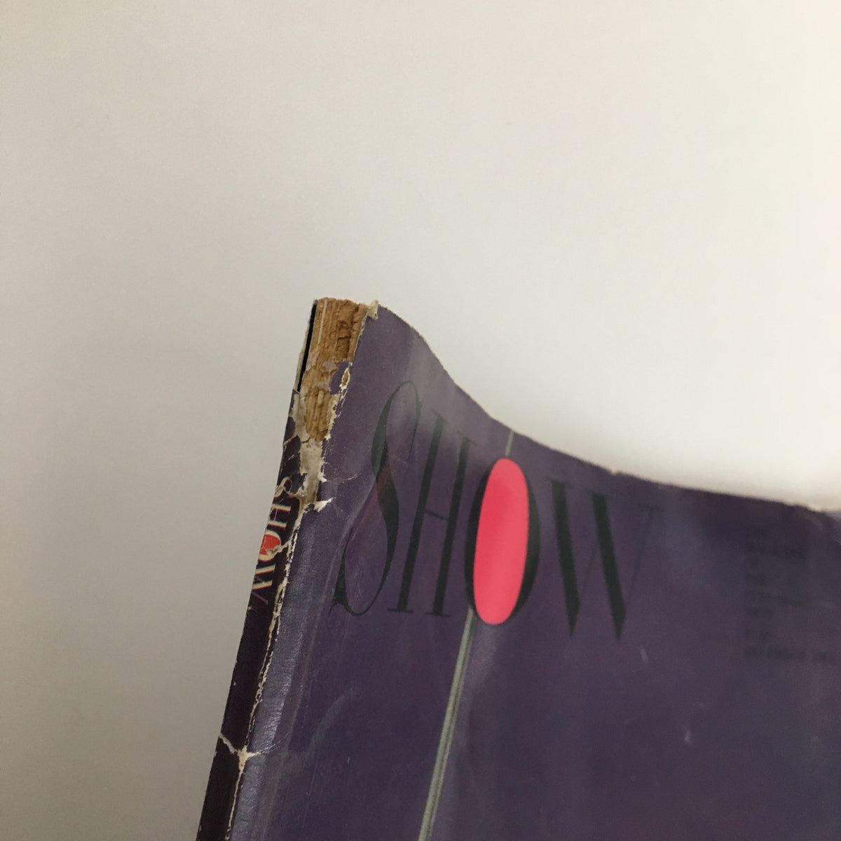 Top edge of Show Magazine December 1961 Vol. 1 No. 3 displaying frayed edges and minor damage, characteristic of vintage magazine wear.