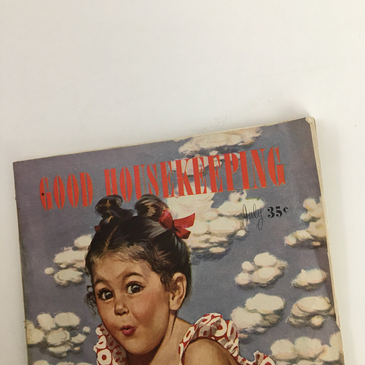 Close-up of the cover of Good Housekeeping Magazine July 1945, showing the magazine's title and price, along with a joyful young girl, embodying the cheerful essence of the post-war era.