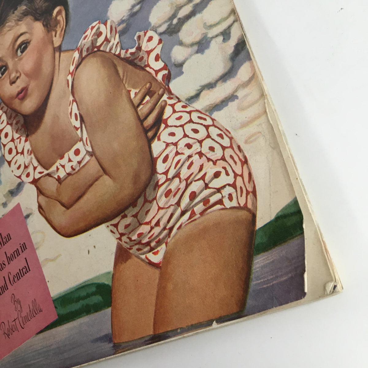 Detailed view of the cover illustration on Good Housekeeping Magazine July 1945, highlighting a girl in a vintage swimsuit with a playful expression, and the text for an article by Robert Candella.