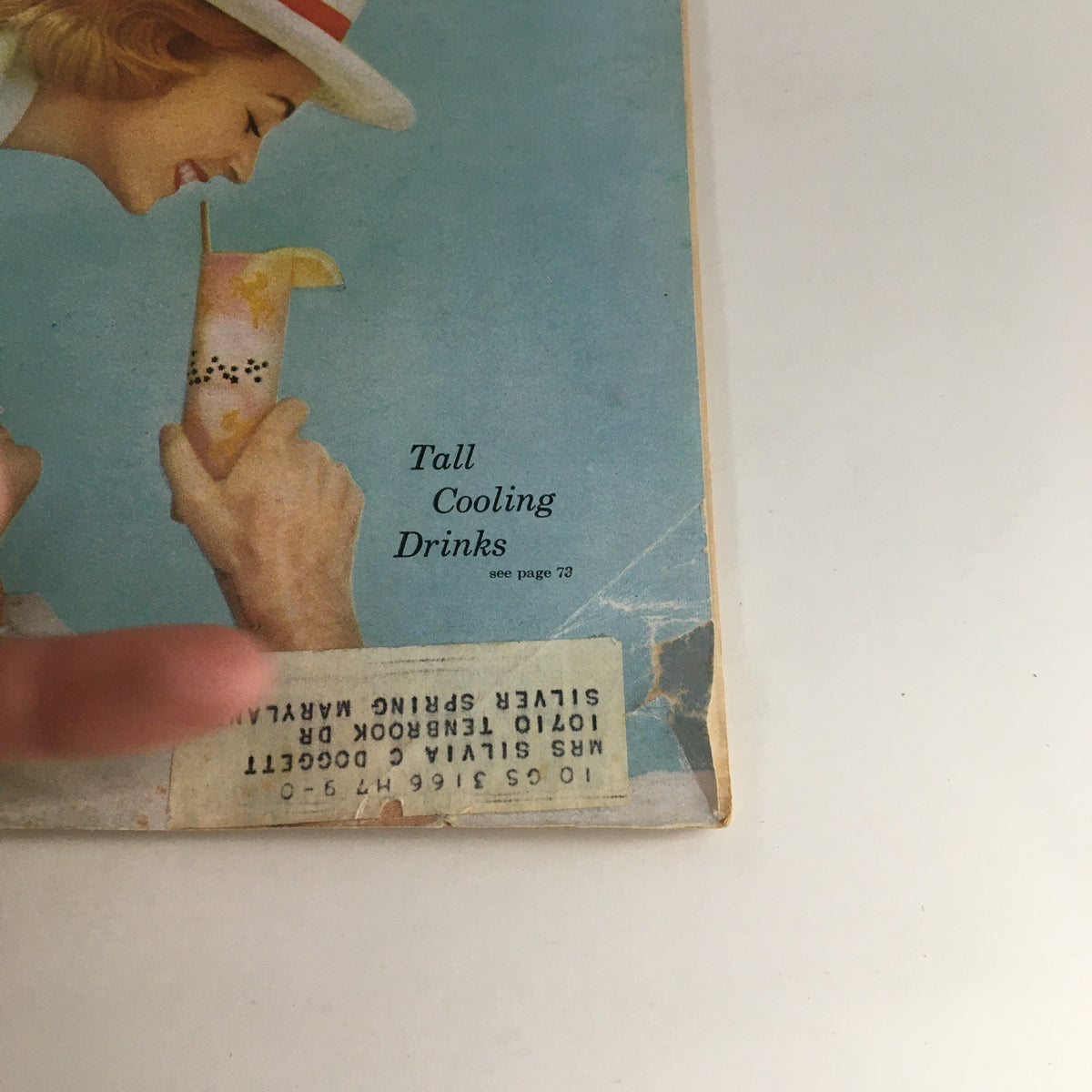Close-up of the cover of Redbook Magazine, August 1958, showing a whimsical illustration related to a feature on 'Tall Cooling Drinks'. The magazine is adorned with an address label, adding to its vintage character.