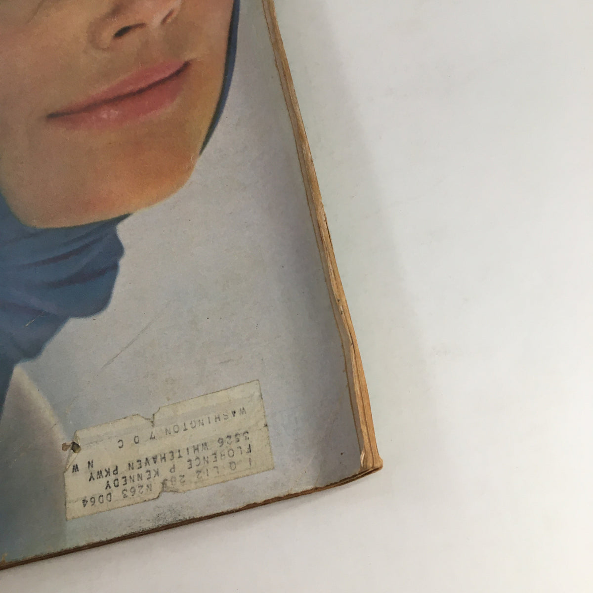 Close-up of the Redbook Magazine April 1964 cover showing the model's face and the address label, highlighting the vintage style and nostalgic appeal of the publication.