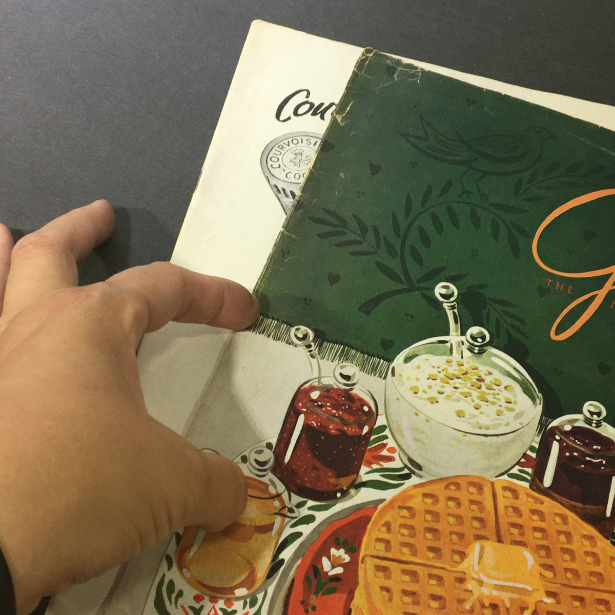 Close-up of the January 1948 cover of VTG Gourmet: The Magazine of Good Living with hand holding the edge, highlighting the vintage design.