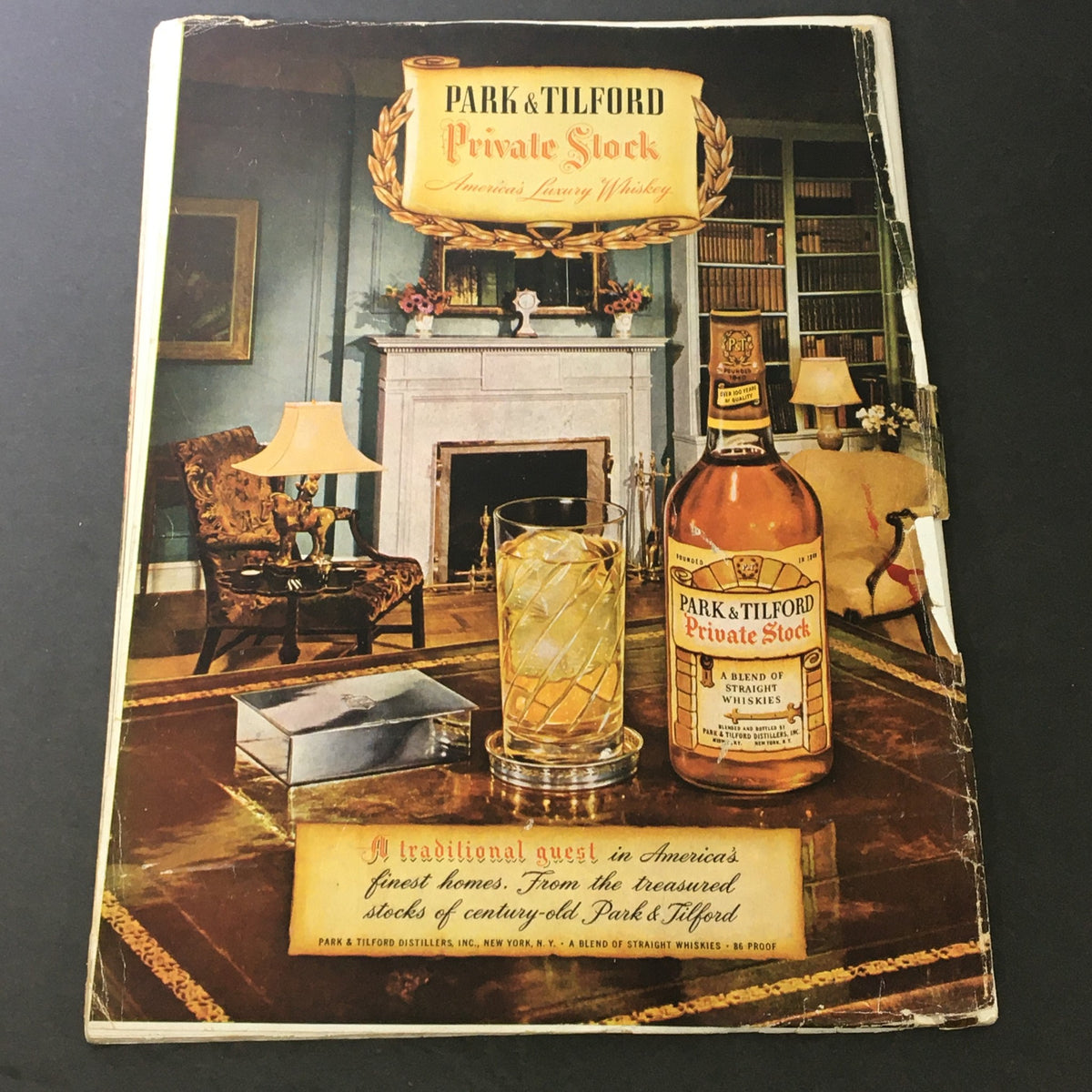 Back cover of the January 1948 edition of VTG Gourmet: The Magazine of Good Living, featuring an ad for Park & Tilford whiskey, illustrating a cozy living room setting.